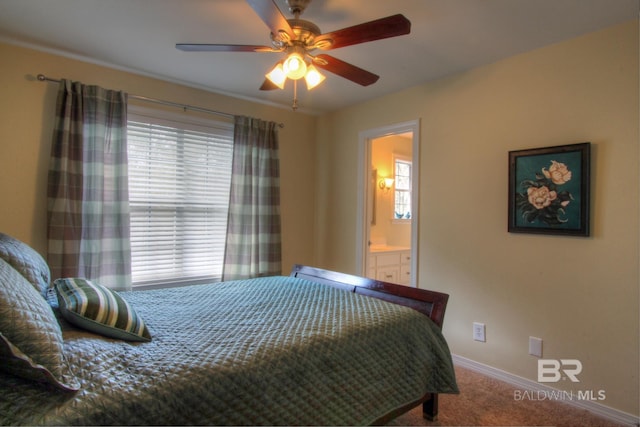 carpeted bedroom featuring baseboards, a ceiling fan, and ensuite bathroom