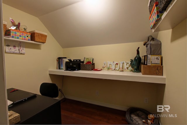 home office with vaulted ceiling and dark wood-type flooring