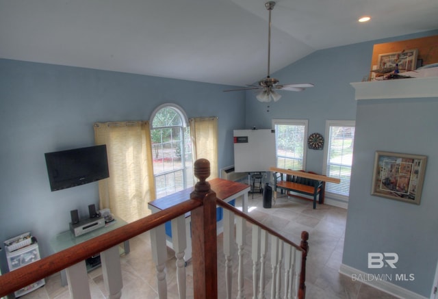 corridor with lofted ceiling, a healthy amount of sunlight, an upstairs landing, and tile patterned floors