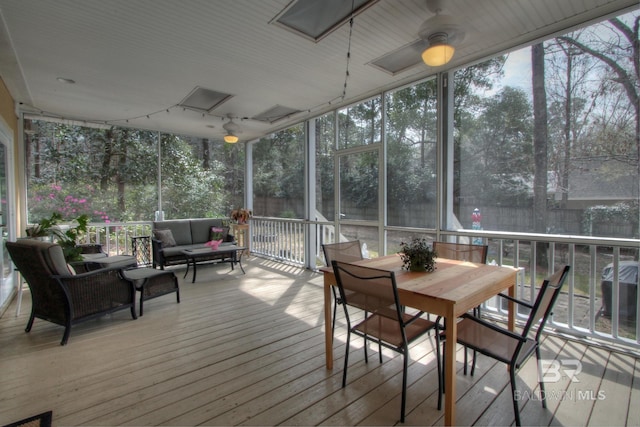 sunroom / solarium featuring ceiling fan