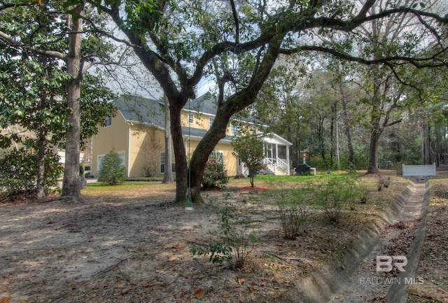 view of front of property featuring a sunroom and stucco siding