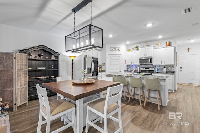 4142 Montague Dr, Gulf Shores, AL 36542 - dining space with light wood finished floors and recessed lighting