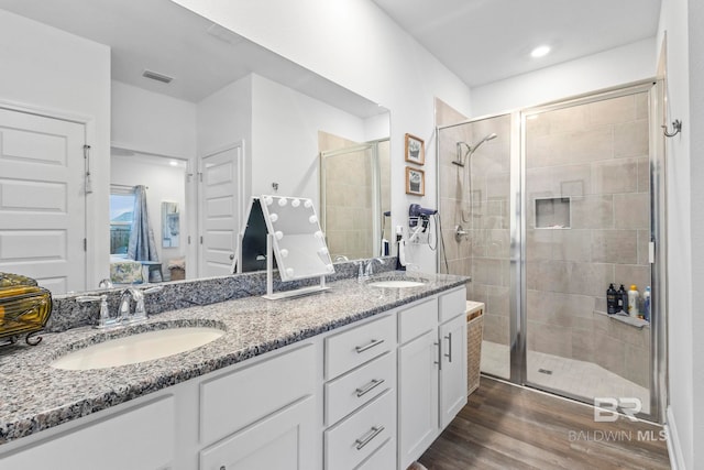 4142 Montague Dr, Gulf Shores, AL 36542 - full bathroom featuring ensuite bath, a shower stall, double vanity, and wood finished floors