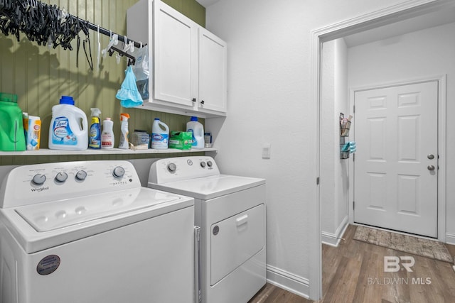 4142 Montague Dr, Gulf Shores, AL 36542 - laundry room featuring washing machine and clothes dryer, cabinet space, dark wood-style flooring, and baseboards