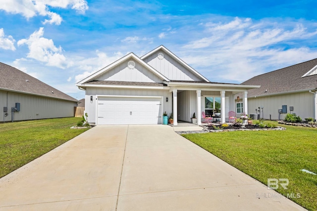 4142 Montague Dr, Gulf Shores, AL 36542 - view of front of property featuring board and batten siding, a front lawn, an attached garage, concrete driveway, and a porch