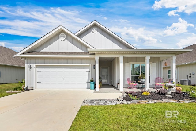 4142 Montague Dr, Gulf Shores, AL 36542 - view of front of property featuring board and batten siding, covered porch, an attached garage, driveway, and roof with shingles