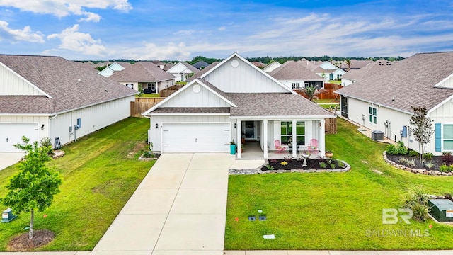 4142 Montague Dr, Gulf Shores, AL 36542 - view of front of property with board and batten siding, a front lawn, driveway, and a residential view