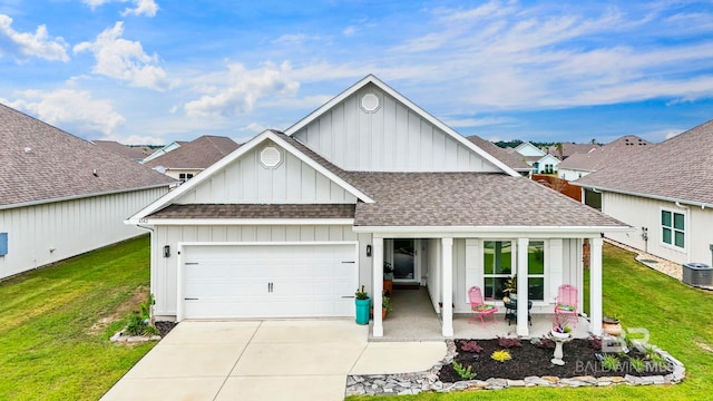4142 Montague Dr, Gulf Shores, AL 36542 - view of front of property with board and batten siding, a shingled roof, a garage, and a front yard