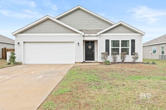 view of front of property featuring central air condition unit, a front yard, and a garage