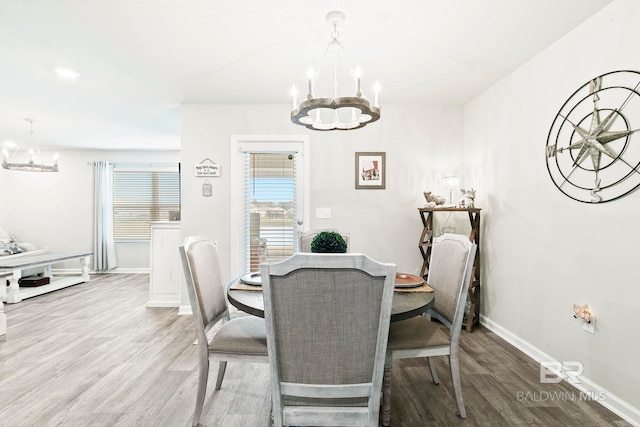 dining area featuring hardwood / wood-style floors and a chandelier