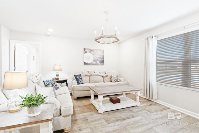 living room featuring light hardwood / wood-style flooring and an inviting chandelier