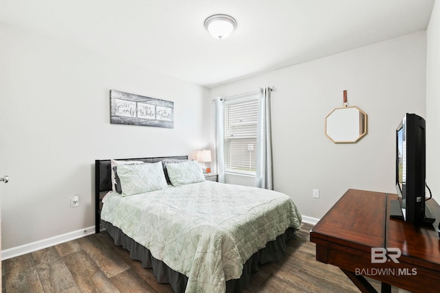 bedroom with dark hardwood / wood-style flooring