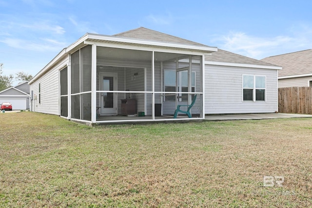 back of house with a lawn, a patio area, and a sunroom