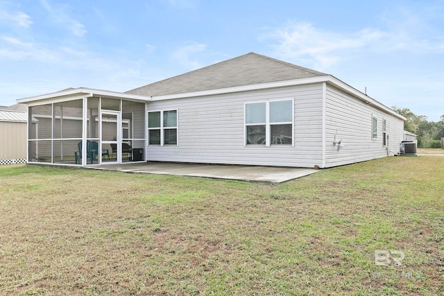 rear view of house featuring a yard, a patio, cooling unit, and a sunroom