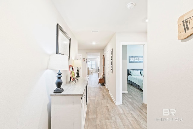 hall with light hardwood / wood-style floors