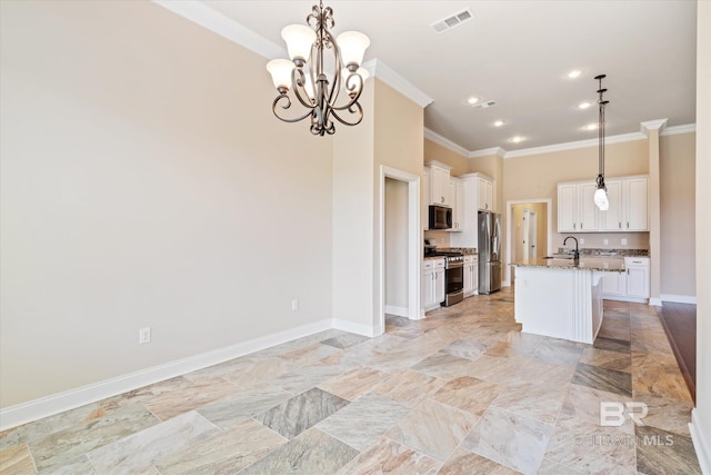 kitchen featuring appliances with stainless steel finishes, a center island with sink, stone counters, and hanging light fixtures