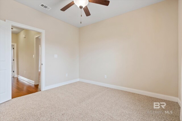 spare room with ceiling fan and hardwood / wood-style flooring