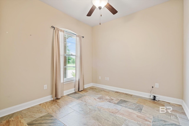 spare room featuring plenty of natural light and ceiling fan