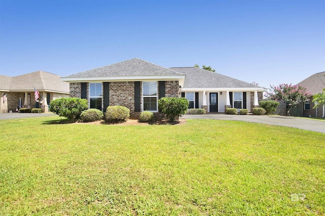 16529 Cold Mill Loop, Foley, AL 36535 - view of front of house with brick siding, a front yard, and roof with shingles