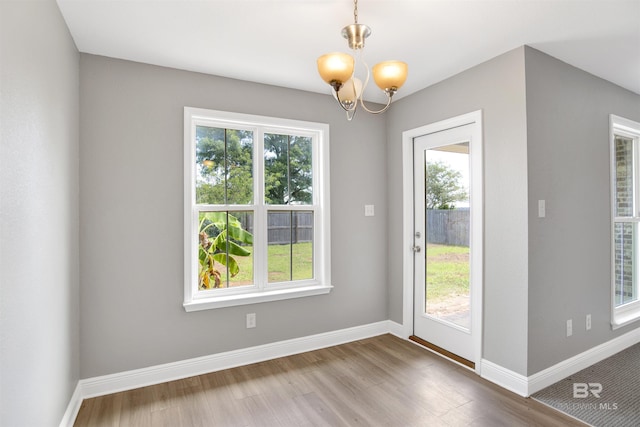 16529 Cold Mill Loop, Foley, AL 36535 - doorway with healthy amount of natural light, wood finished floors, and a chandelier