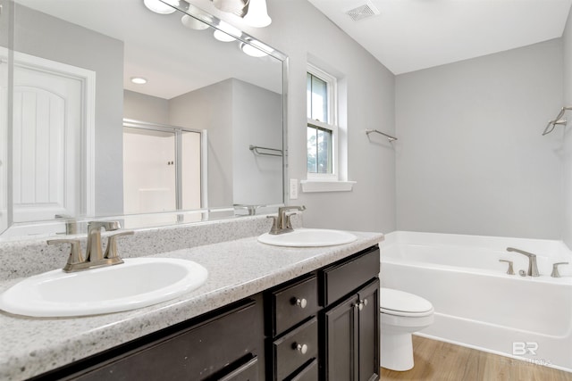 16529 Cold Mill Loop, Foley, AL 36535 - full bath featuring a bath, double vanity, a stall shower, and wood finished floors