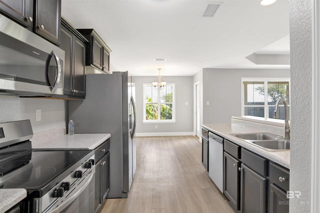 16529 Cold Mill Loop, Foley, AL 36535 - kitchen featuring stainless steel appliances, light wood-type flooring, a chandelier, and hanging light fixtures