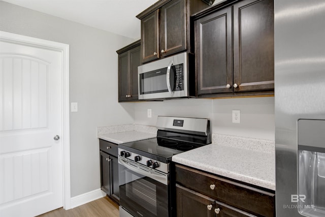 16529 Cold Mill Loop, Foley, AL 36535 - kitchen featuring stainless steel appliances, dark brown cabinetry, and light countertops