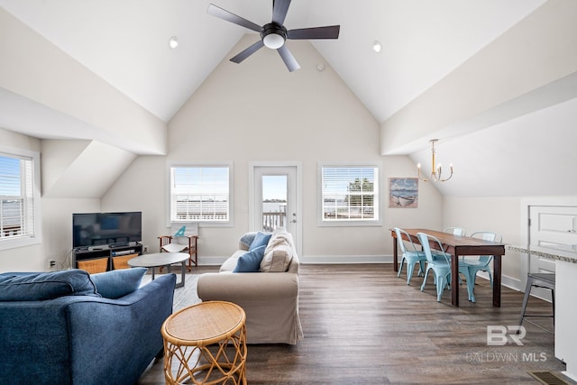 living room with high vaulted ceiling, dark hardwood / wood-style floors, and ceiling fan with notable chandelier