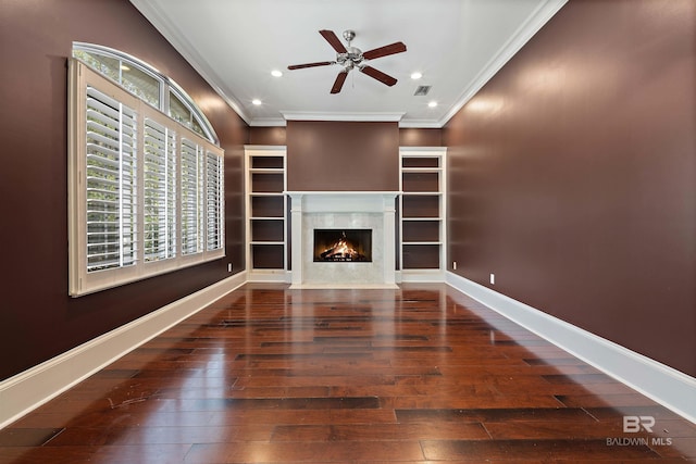 unfurnished living room featuring ceiling fan, a fireplace, dark hardwood / wood-style floors, and ornamental molding