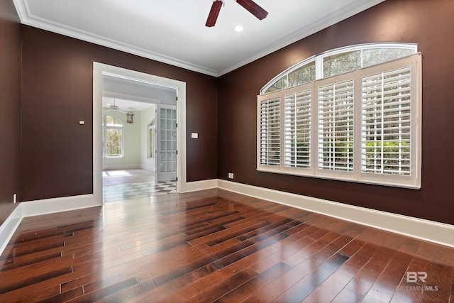 unfurnished room with dark hardwood / wood-style floors, crown molding, and a healthy amount of sunlight