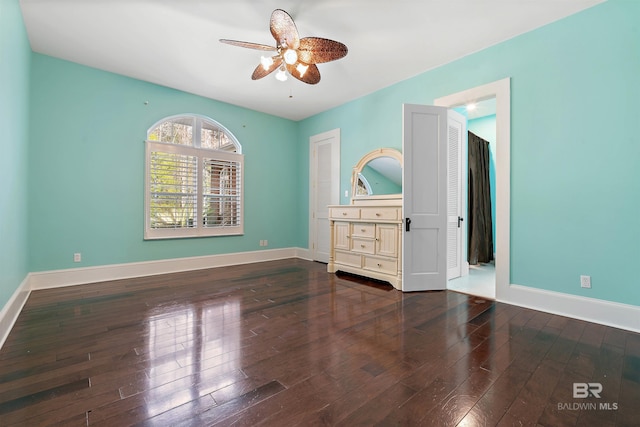 unfurnished bedroom featuring dark hardwood / wood-style floors and ceiling fan