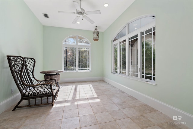 living area with ceiling fan and light tile patterned floors