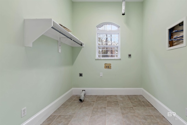 washroom with hookup for an electric dryer, light tile patterned floors, and washer hookup