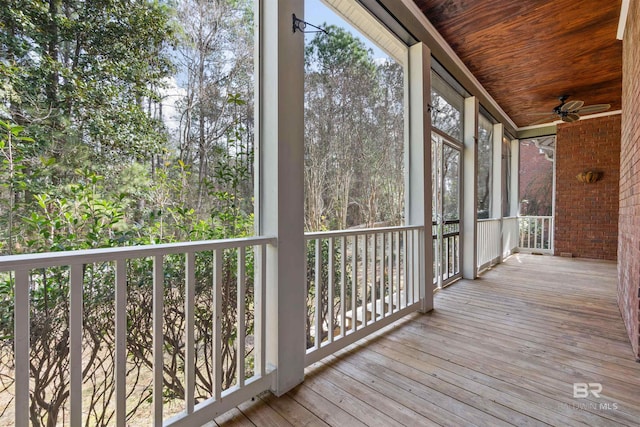 unfurnished sunroom with ceiling fan and wooden ceiling