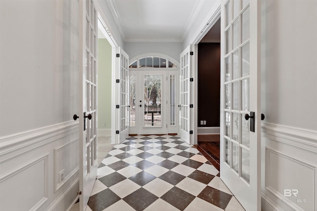 interior space featuring french doors and ornamental molding