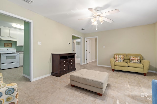 living room with ceiling fan and light tile patterned floors