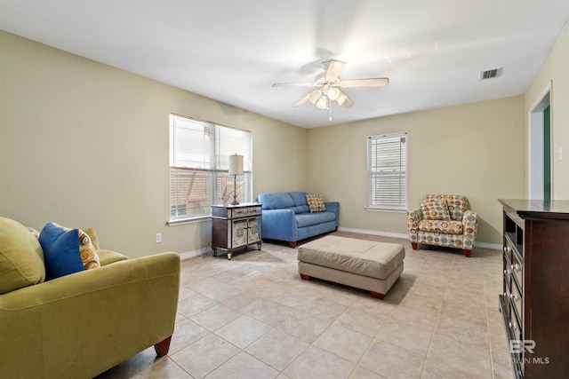 tiled living room featuring ceiling fan