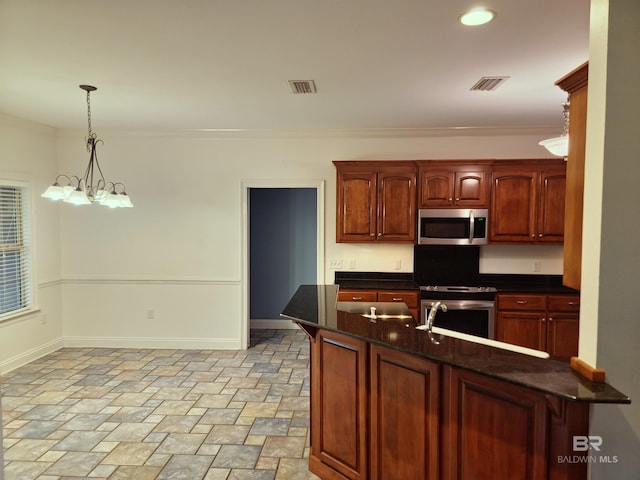 306 S Tee Dr, Fairhope, AL 36532 - kitchen featuring stainless steel appliances, stone finish floors, decorative light fixtures, ornamental molding, and a chandelier