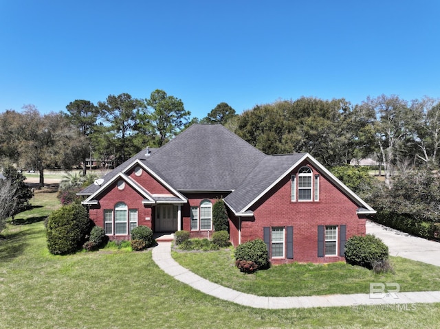 306 S Tee Dr, Fairhope, AL 36532 - traditional-style home featuring brick siding, a front lawn, and roof with shingles