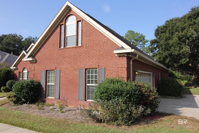 view of side of home featuring a garage