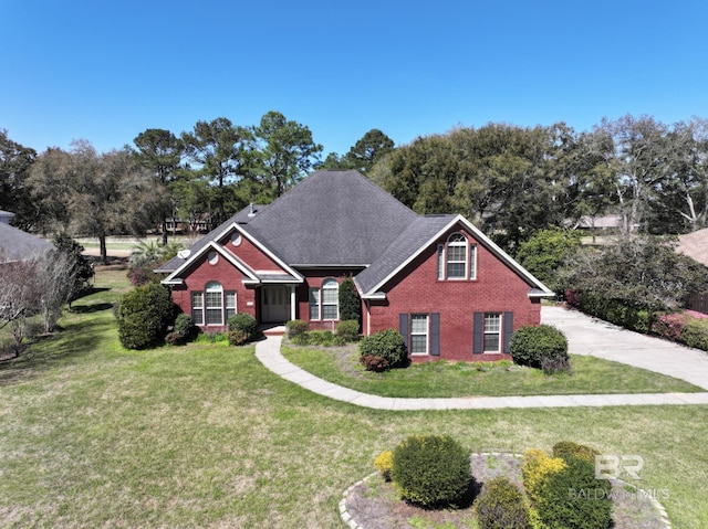 306 S Tee Dr, Fairhope, AL 36532 - traditional home with brick siding, a front lawn, and a shingled roof
