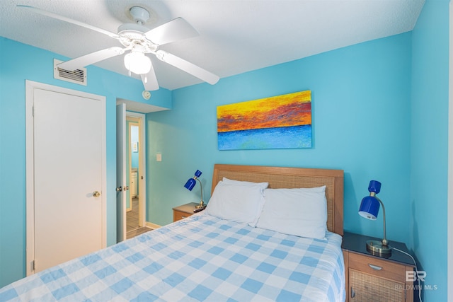 bedroom featuring a textured ceiling and ceiling fan