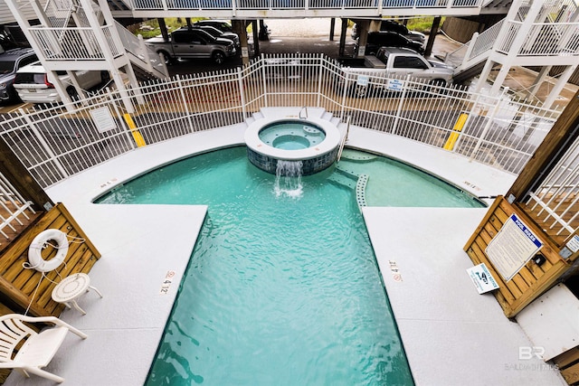 view of swimming pool featuring a community hot tub and pool water feature