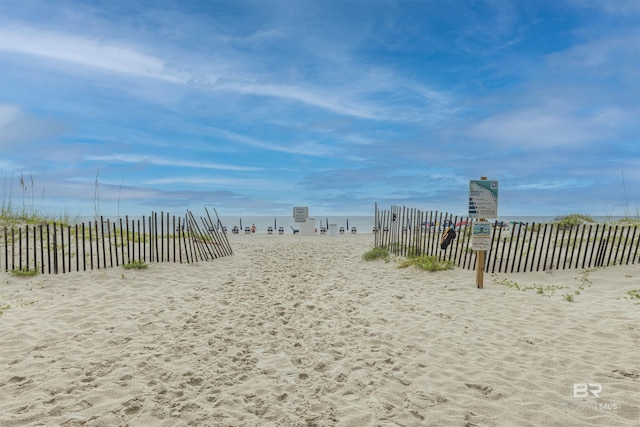 view of community featuring a beach view and a water view