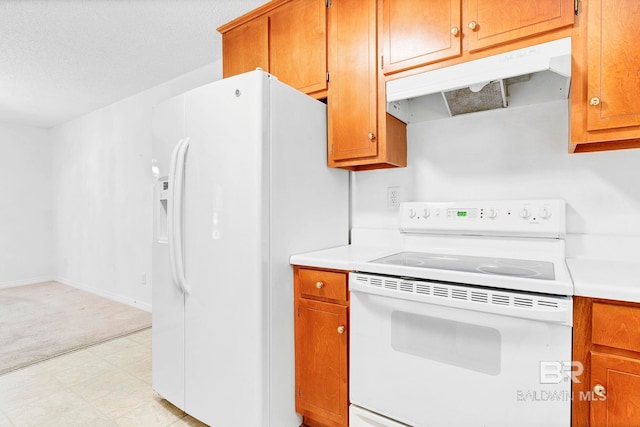 kitchen with under cabinet range hood, light floors, white appliances, and light countertops