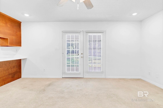 interior space featuring baseboards, recessed lighting, light carpet, and ceiling fan
