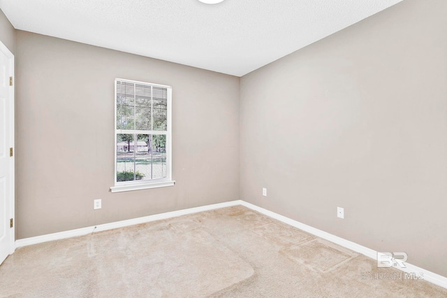 empty room with baseboards and carpet floors