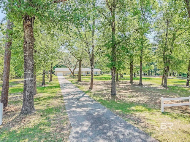 view of home's community featuring a garage and fence