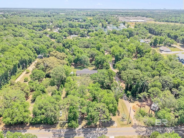 drone / aerial view featuring a wooded view