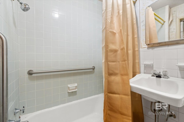 bathroom featuring sink, tile walls, shower / tub combo with curtain, and decorative backsplash